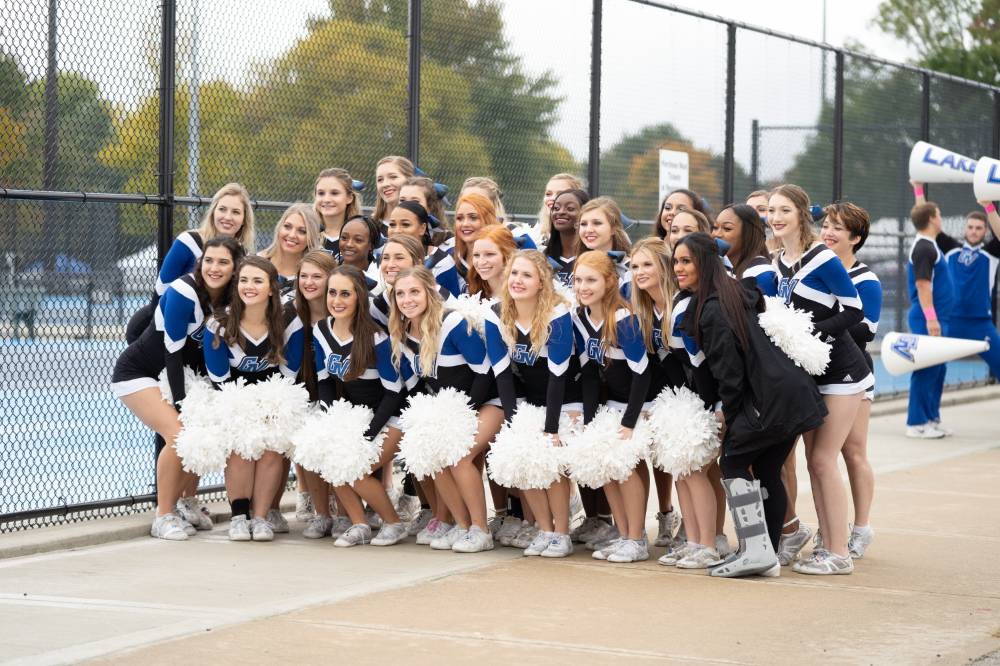 The cheerleaders pose for a group photo at the Alumni Homecoming Tailgate.